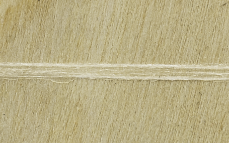 A sheet of wood with Lemtapes adhesive applied.